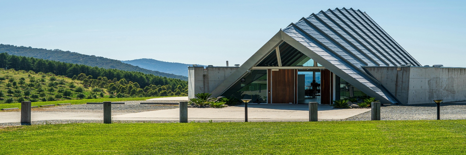 The chapel at a New Zealand vineyard, surrounded by lush vines and scenic landscapes, offers a serene atmosphere.