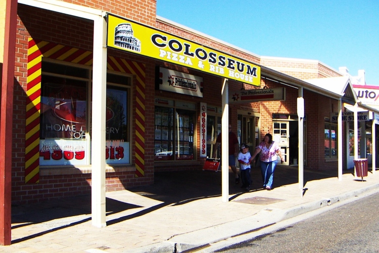 A building in Canberra featuring a prominent sign, indicating it houses various shops.