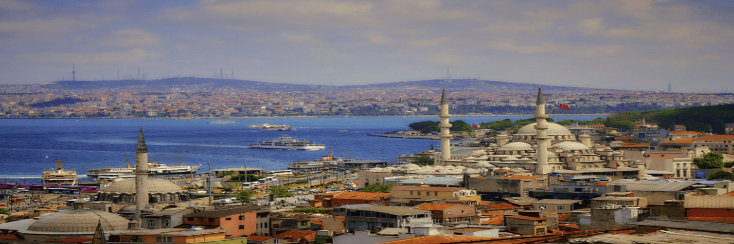 A panoramic view of Istanbul showcasing numerous buildings, including hotels, against a clear blue sky.