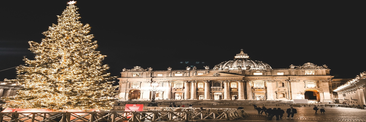 A decorated Christmas tree stands in front of the Vatican, surrounded by a light dusting of snow in Rome.