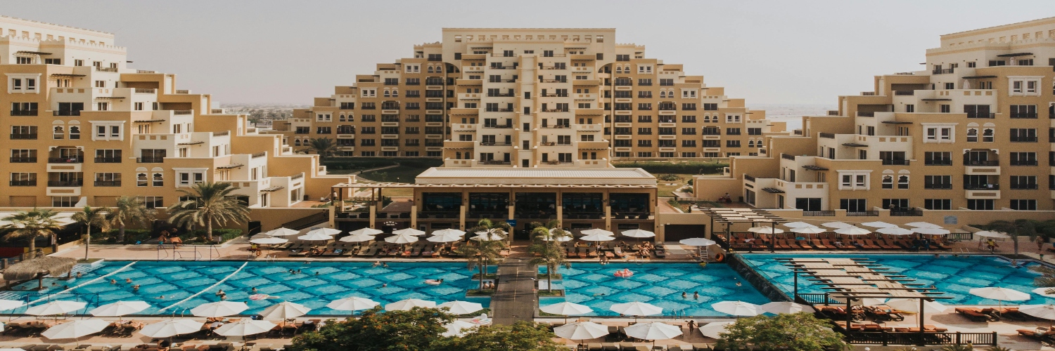 Jumeirah Al Qasr hotel in Dubai, featuring a luxurious pool and resort near Burj Khalifa at the marina.
