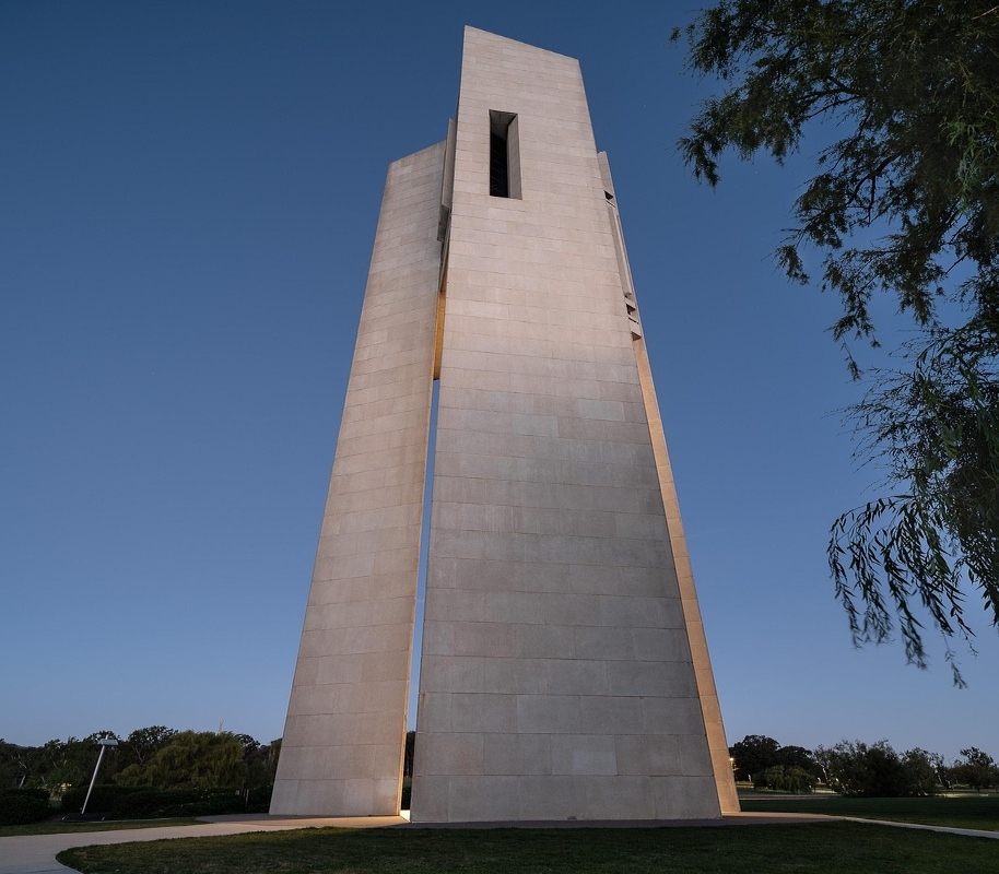 A night view of the monument in Canberra, beautifully lit and glowing against the dark backdrop.