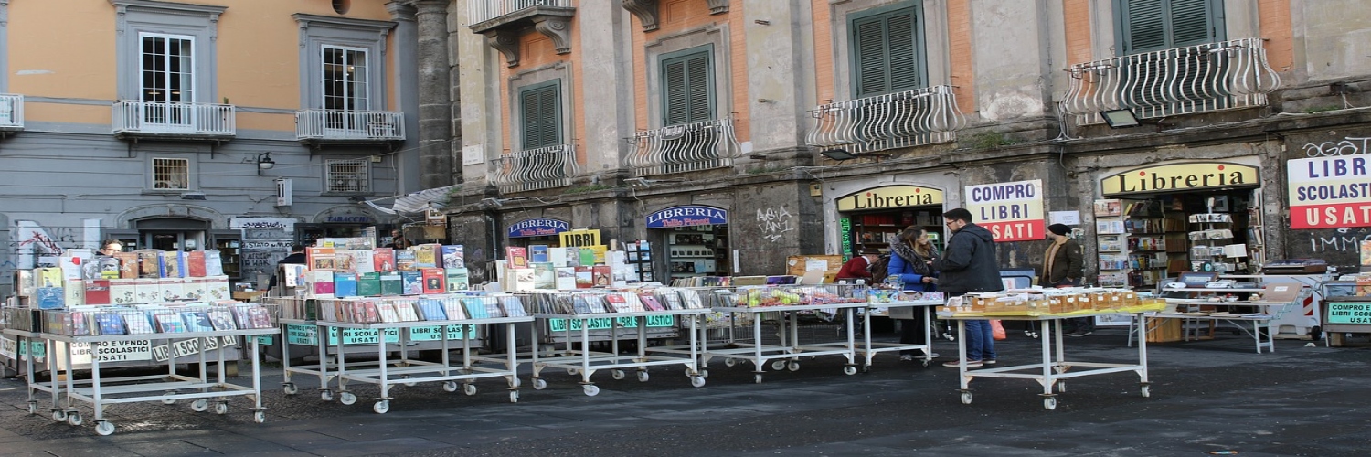 A bustling Library Street in Naples, filled with shops and people walking and enjoying the vibrant atmosphere.
