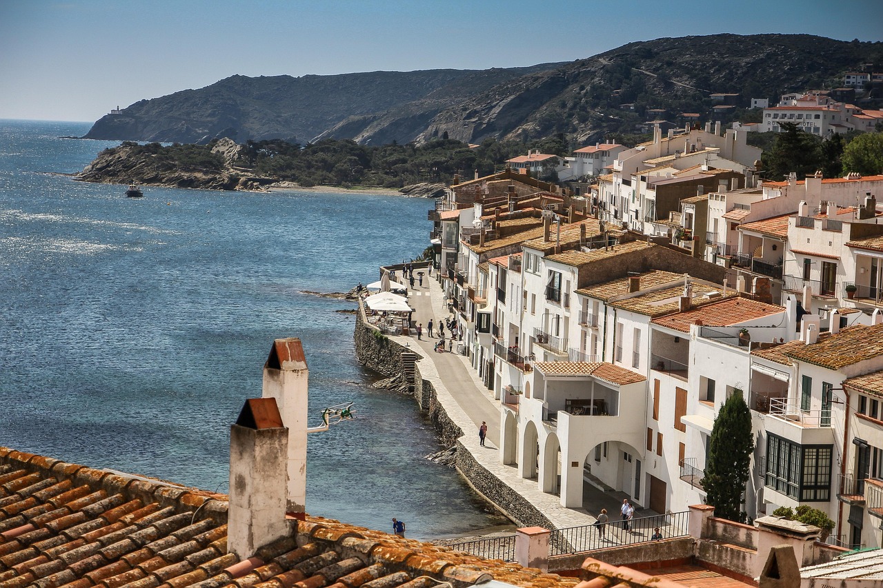 A scenic view of the Costa Brava coastline from a hillside, showcasing cliffs and the Mediterranean Sea.