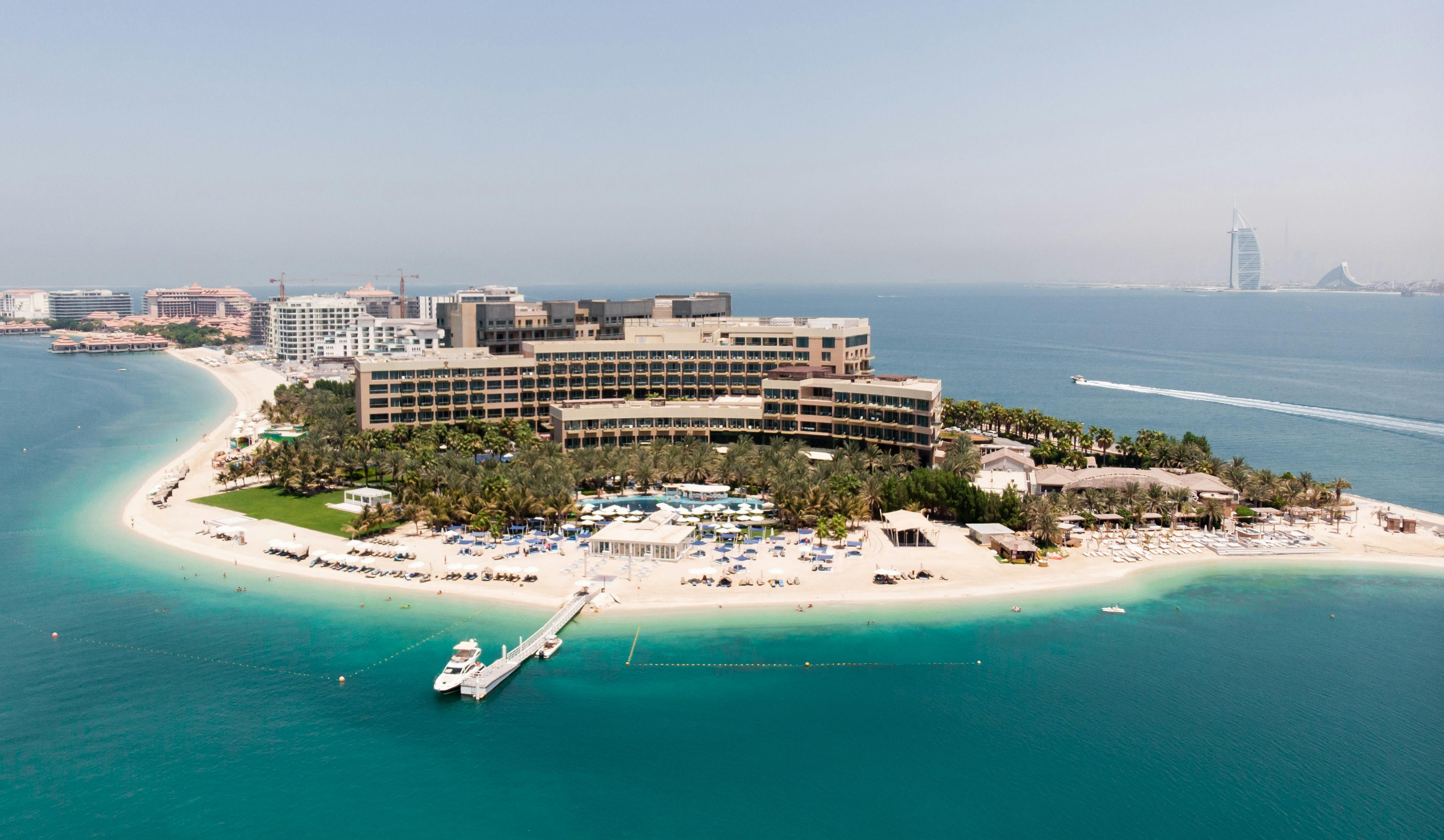 Aerial view of beautiful Resort & Spa, an island surrounded by water near Burj Khalifa, showcasing luxury and relaxation.