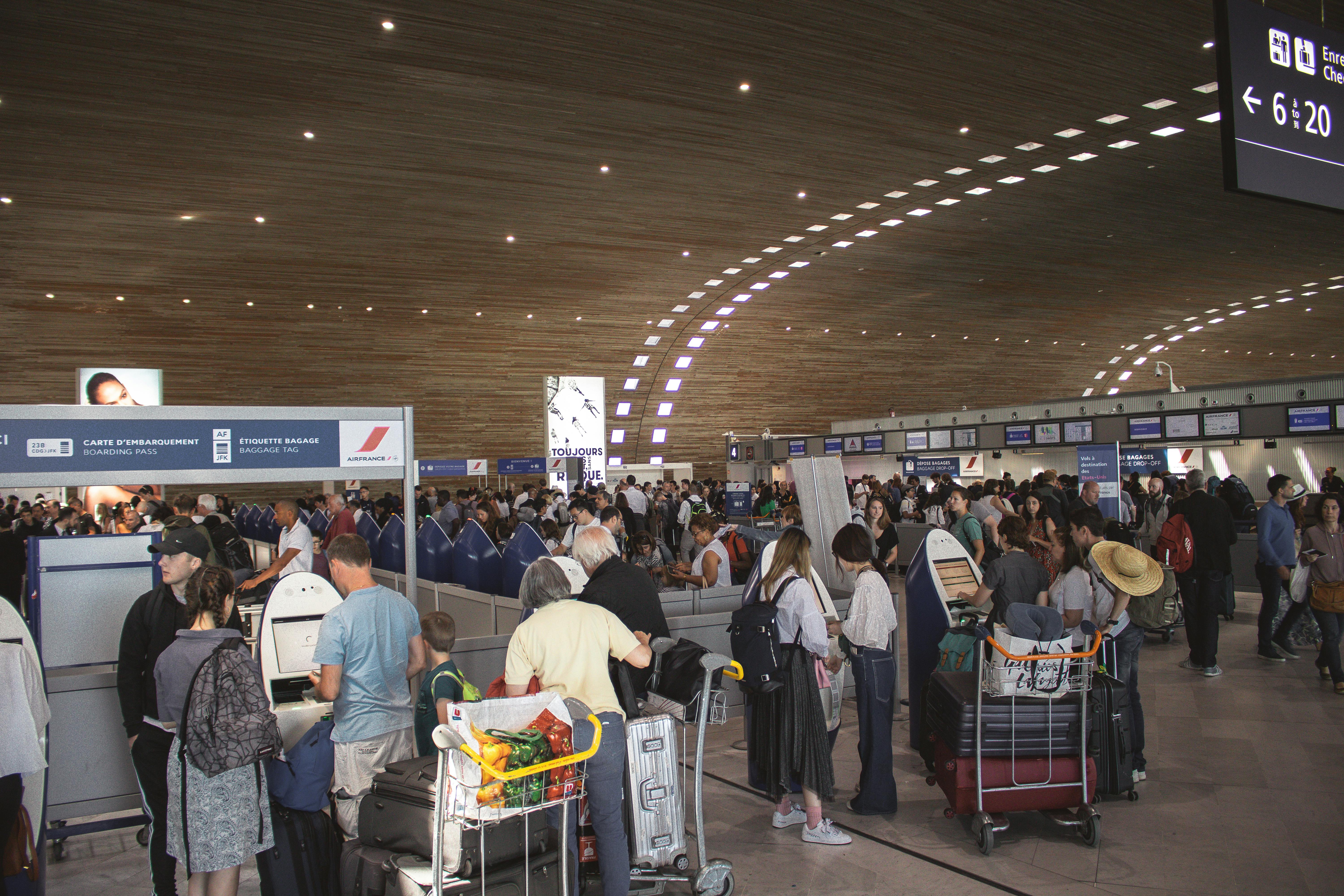 A large group of people gathered together, with the closest airport to Paris in the background.