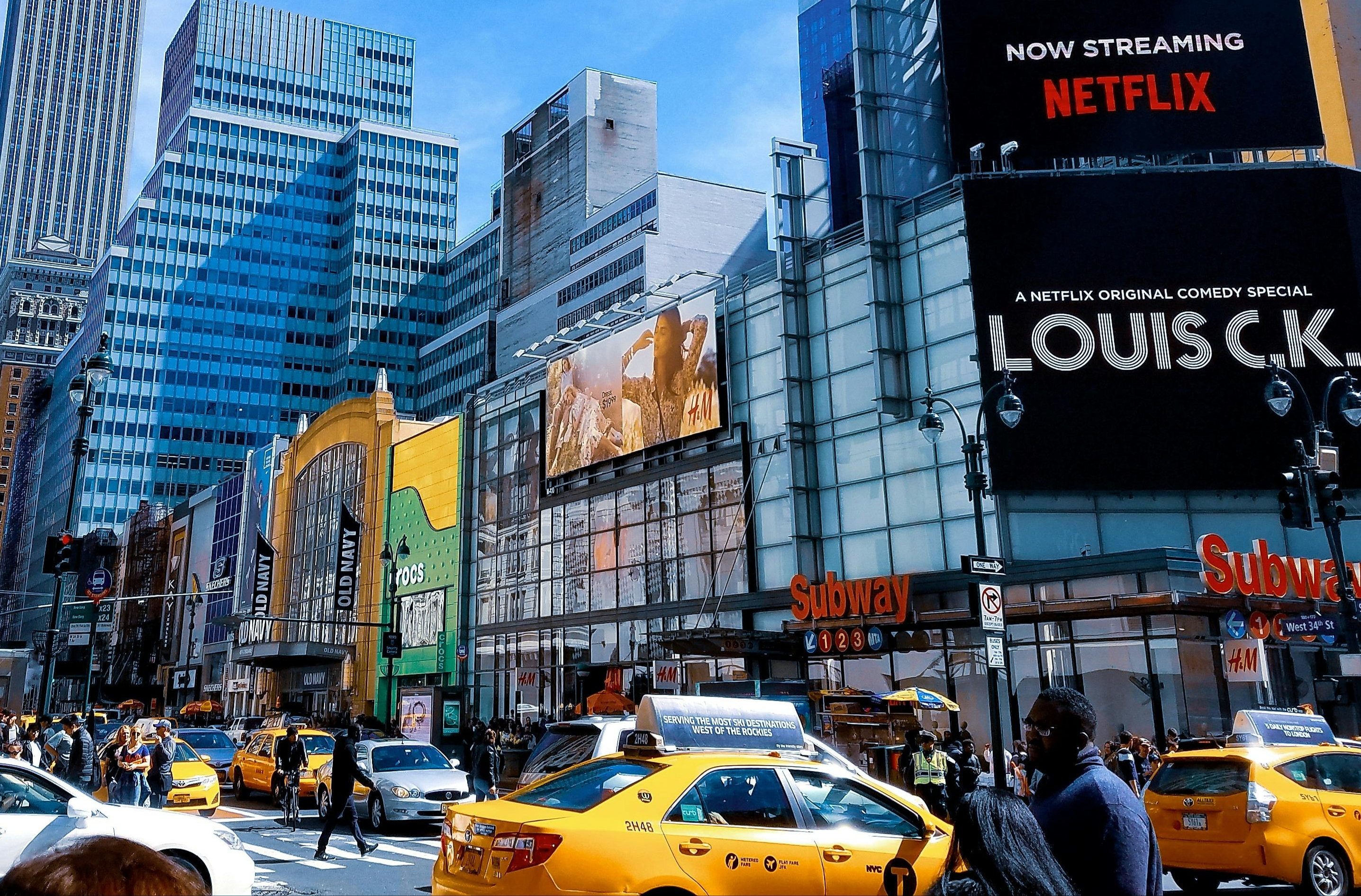 A bustling Paris street filled with taxis and cars, featuring a sign for Eiffel Tower taxi fares.