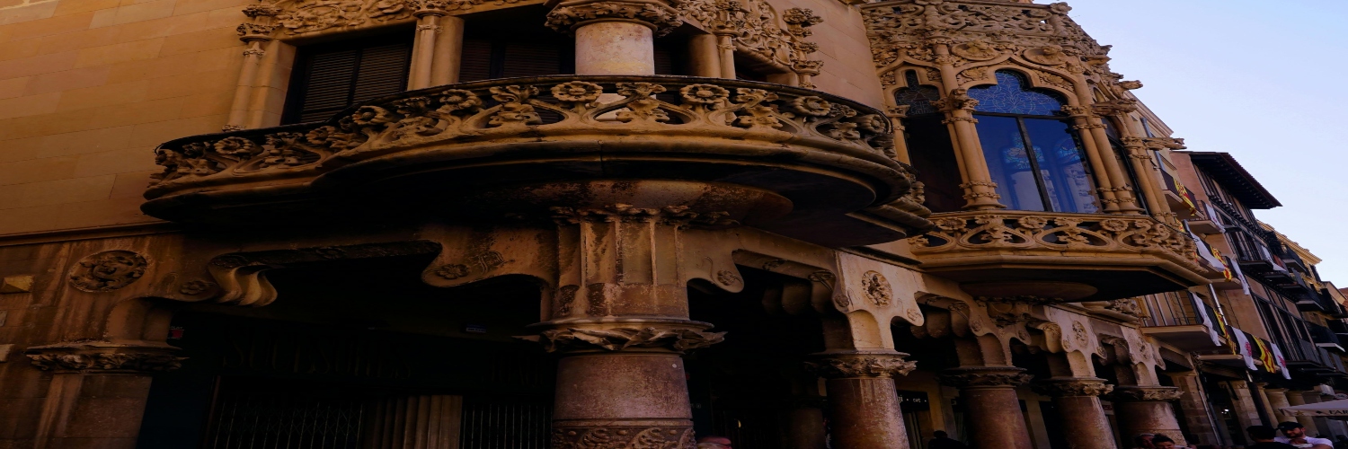 Ornate traditional tenement building featuring intricate balconies and columns.