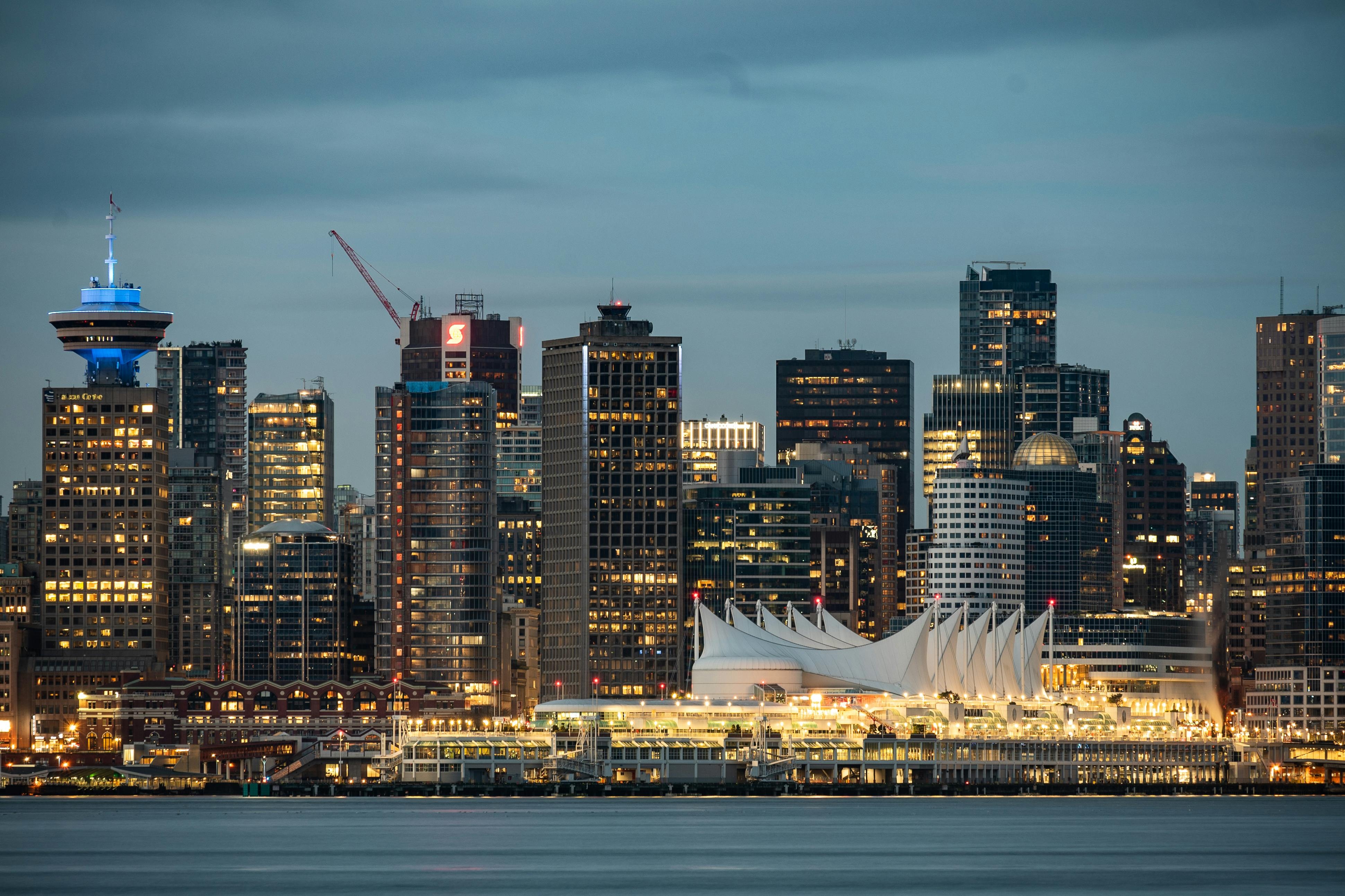 Night view of Vancouver's skyline, with bright lights highlighting the city's architecture.