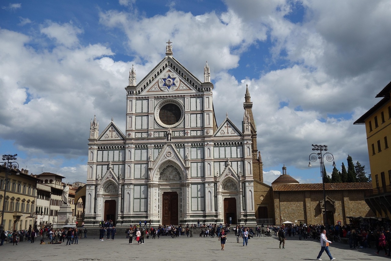 The Cathedral of Siena, located in Florence, Italy, features impressive Gothic architecture and ornate facades, surrounded by historic buildings.