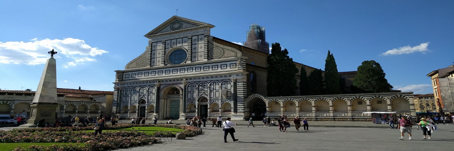 The Cathedral of Siena, Italy, showcasing its intricate Gothic architecture and stunning façade against a clear blue sky.
