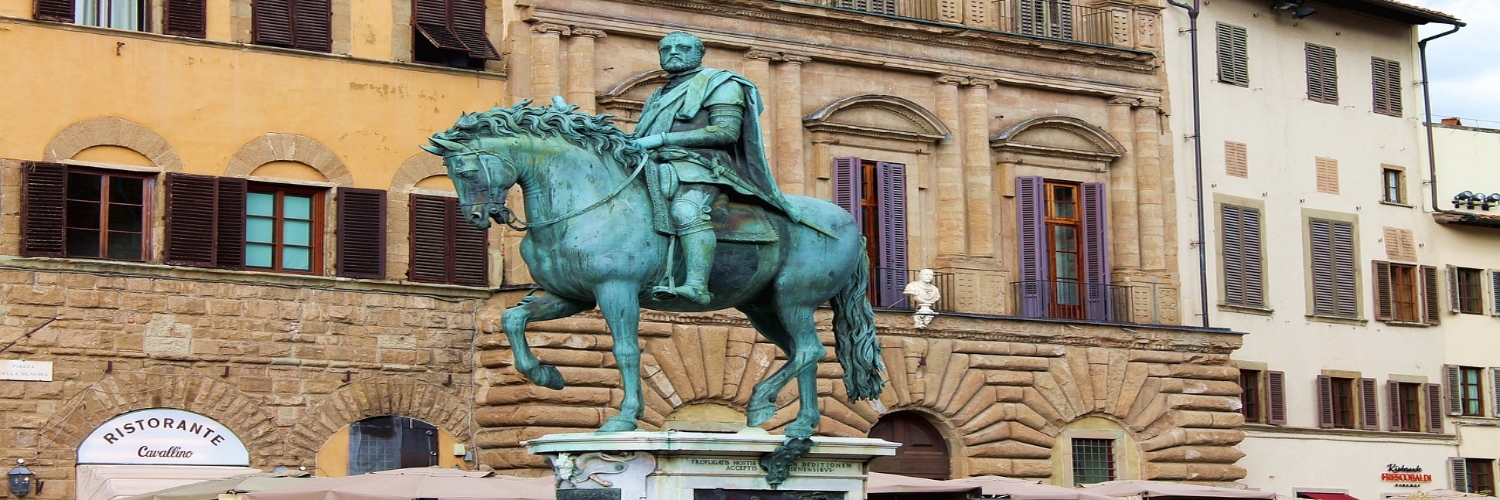 Statue of a man on a horse in Piazza della Signoria, showcasing historical art and architecture.