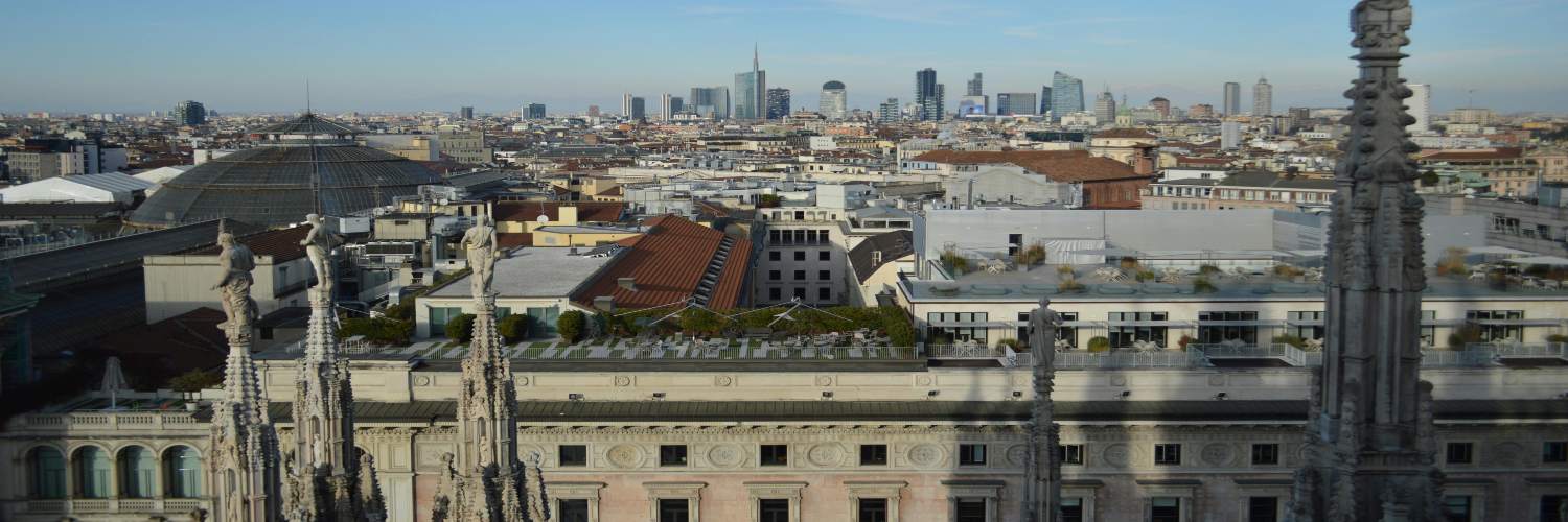 Panoramic view of Milan's cityscape from above, showcasing iconic buildings and vibrant urban life.
