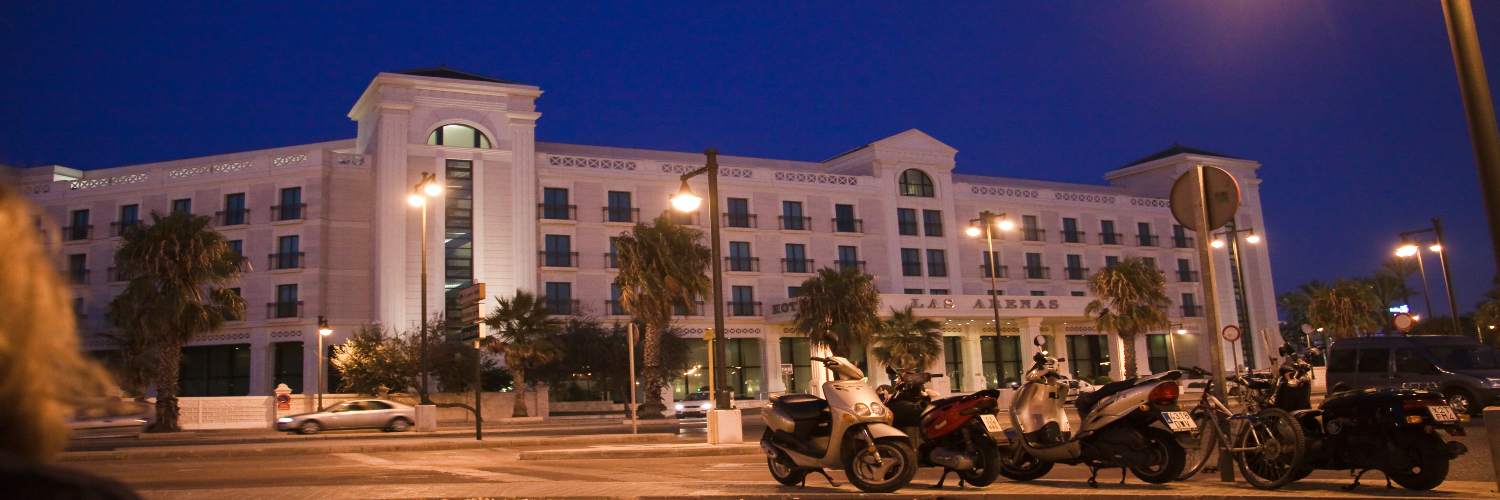 Exterior view of the Valencia Airport Hotel, showcasing its modern architecture and surrounding landscape.