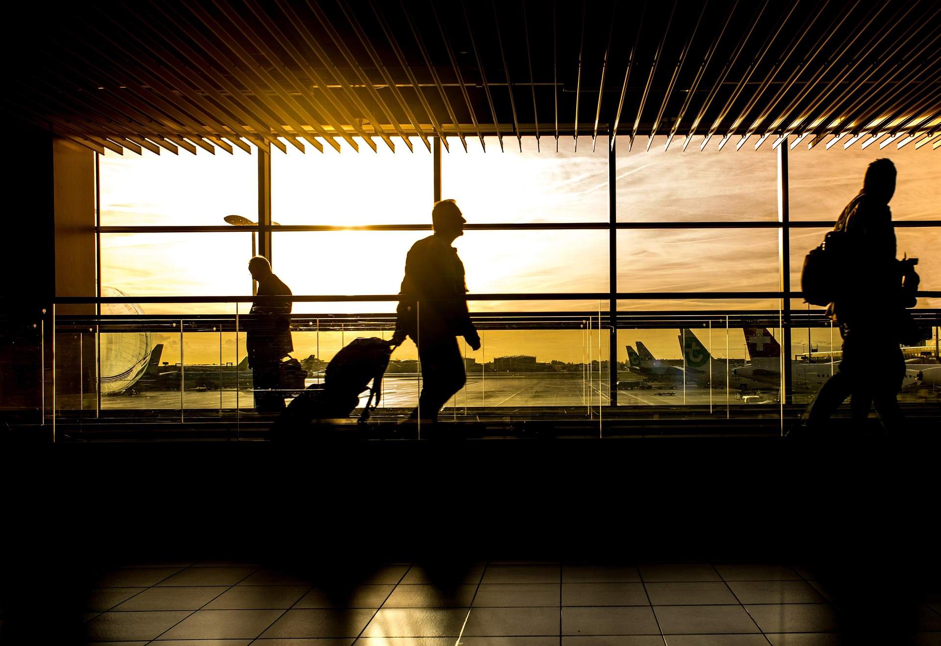 People walking through Paris Airport, navigating the terminal during a busy transfer period.