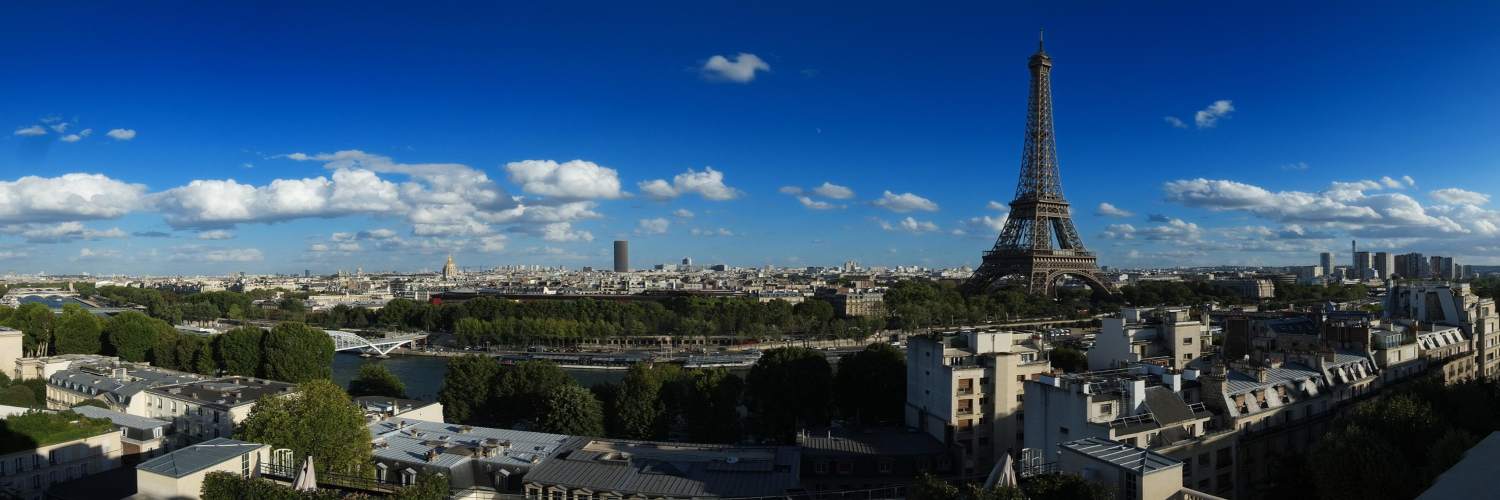 The Eiffel Tower stands tall in Paris, France, with a view of the city skyline in the background.