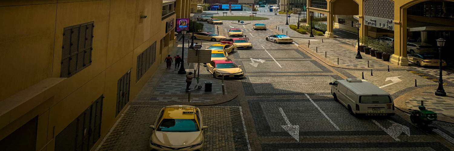A vibrant street filled with yellow taxis and parked cars, representing the bustling traffic in Dubai.