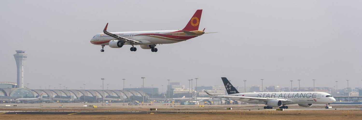 A plane taking off from an airport, symbolizing an airport transfer from Dubai.