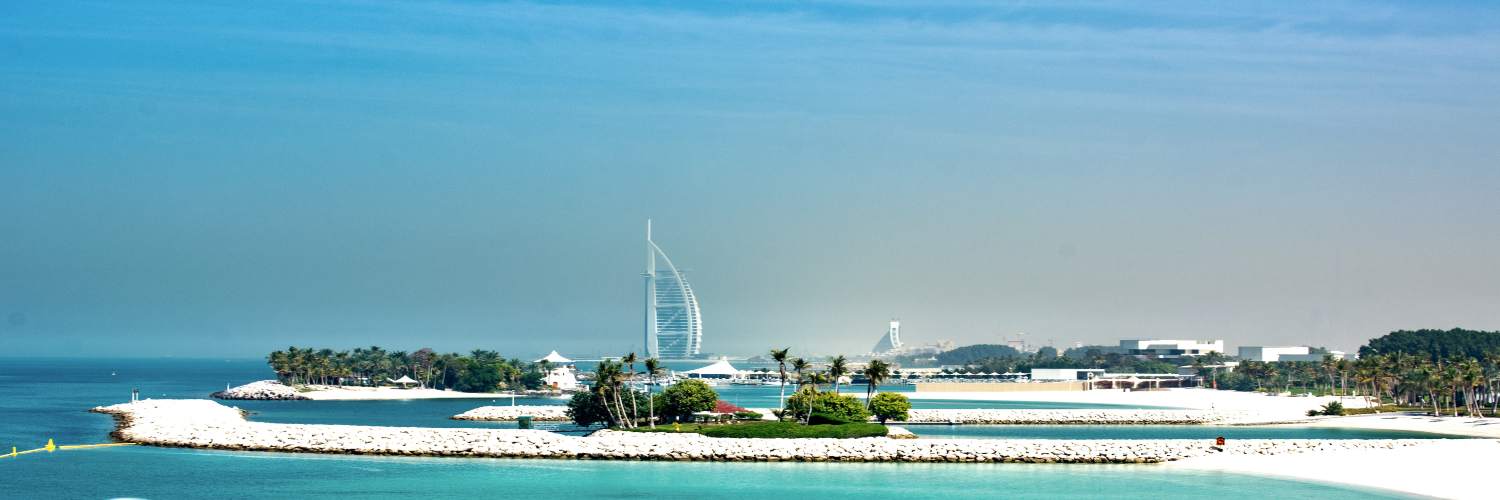 Scenic view of the beach with the iconic Burj Al Arab in the background, showcasing luxury near Burj Khalifa.