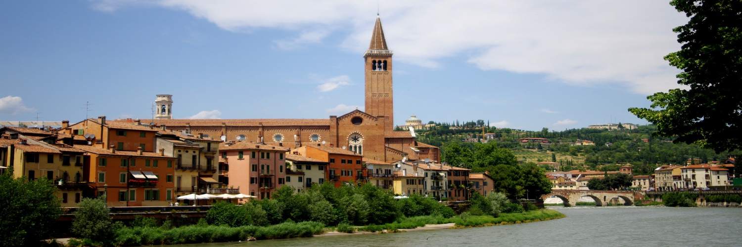 A scenic view of a river flowing through the town of Bologna, showcasing its charming architecture and vibrant atmosphere.
