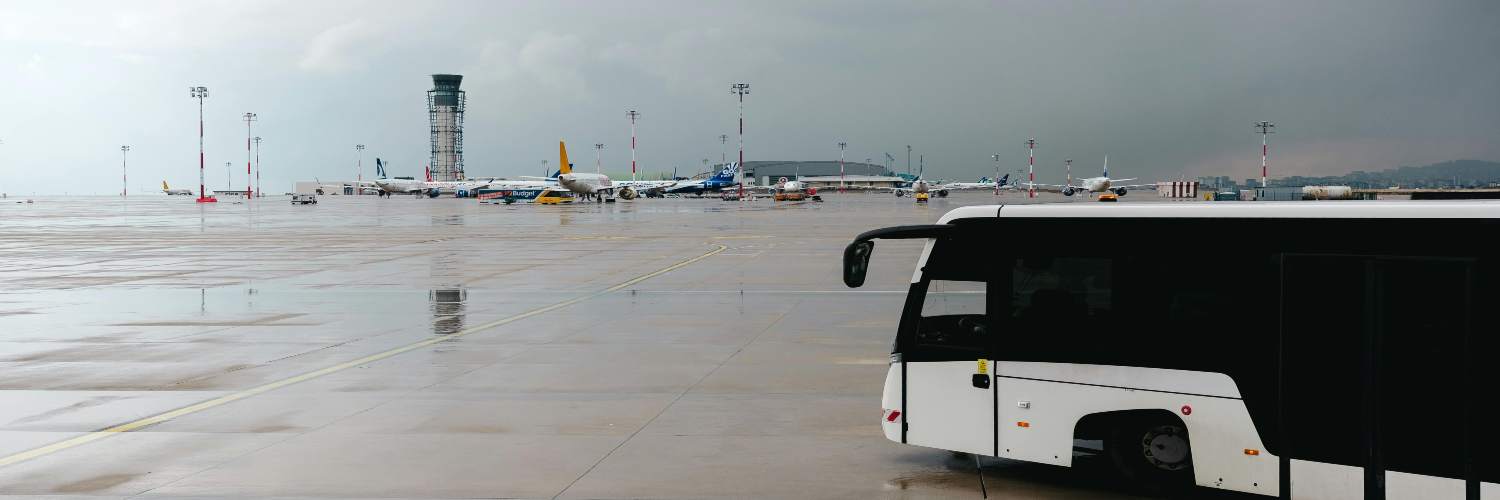 A black and white airport bus, typical for London transport services.