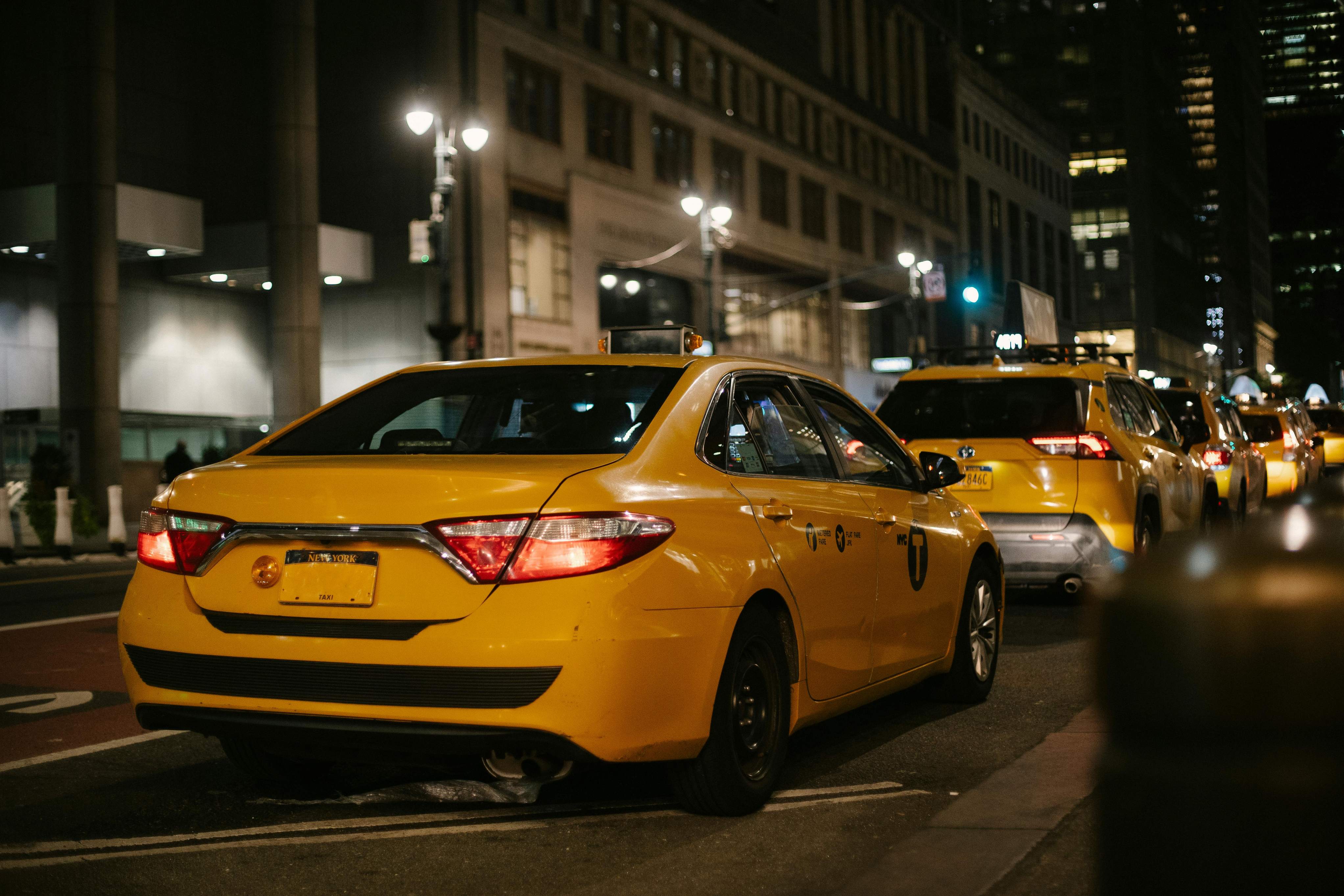 A bustling city street filled with yellow cabs and pedestrians navigating through traffic.