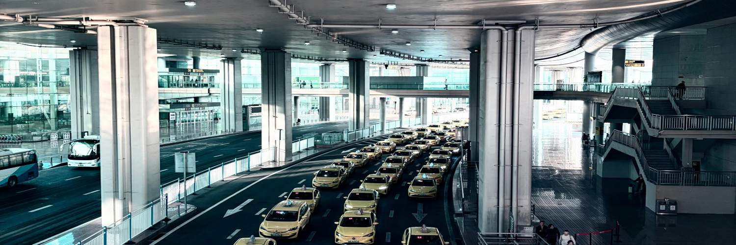 Airport taxi cabs waiting outside Thailand airport, offering rides to incoming passengers.
