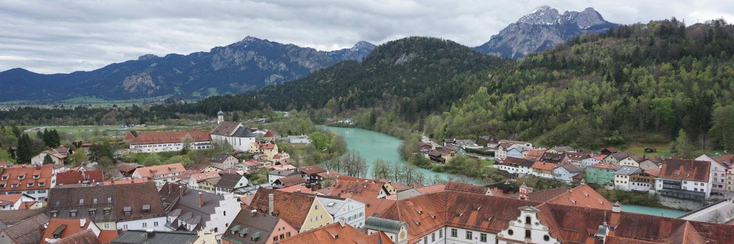Scenic view of Salzburg, Austria, featuring the river and mountains, with charming Bavarian villages in the foreground.
