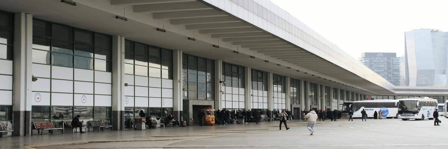 A busy airport terminal filled with people walking, carrying luggage, and engaging in various activities.