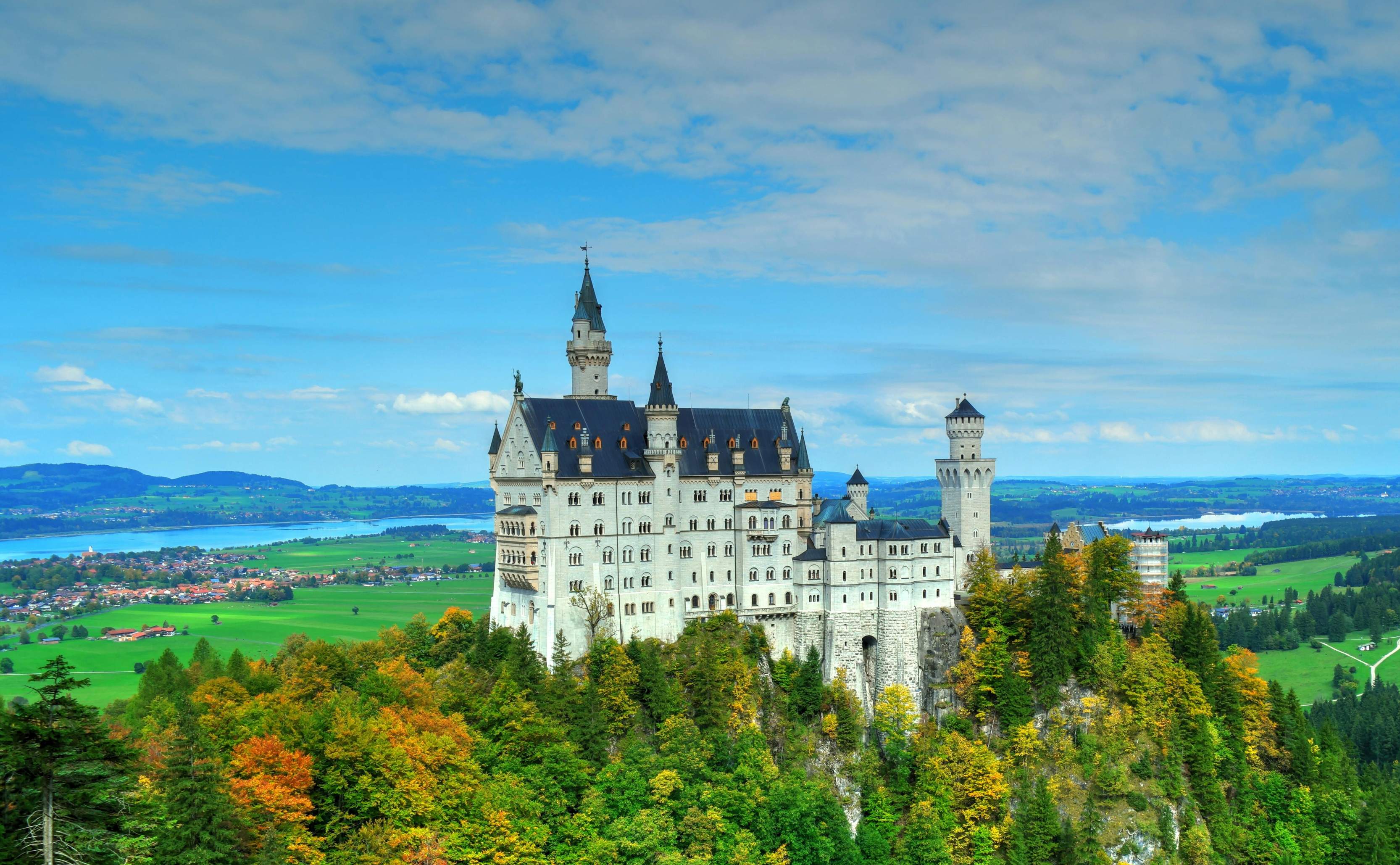 Neuschwanstein Castle in Bavaria, Germany, showcasing its fairy-tale architecture against a scenic mountain backdrop.