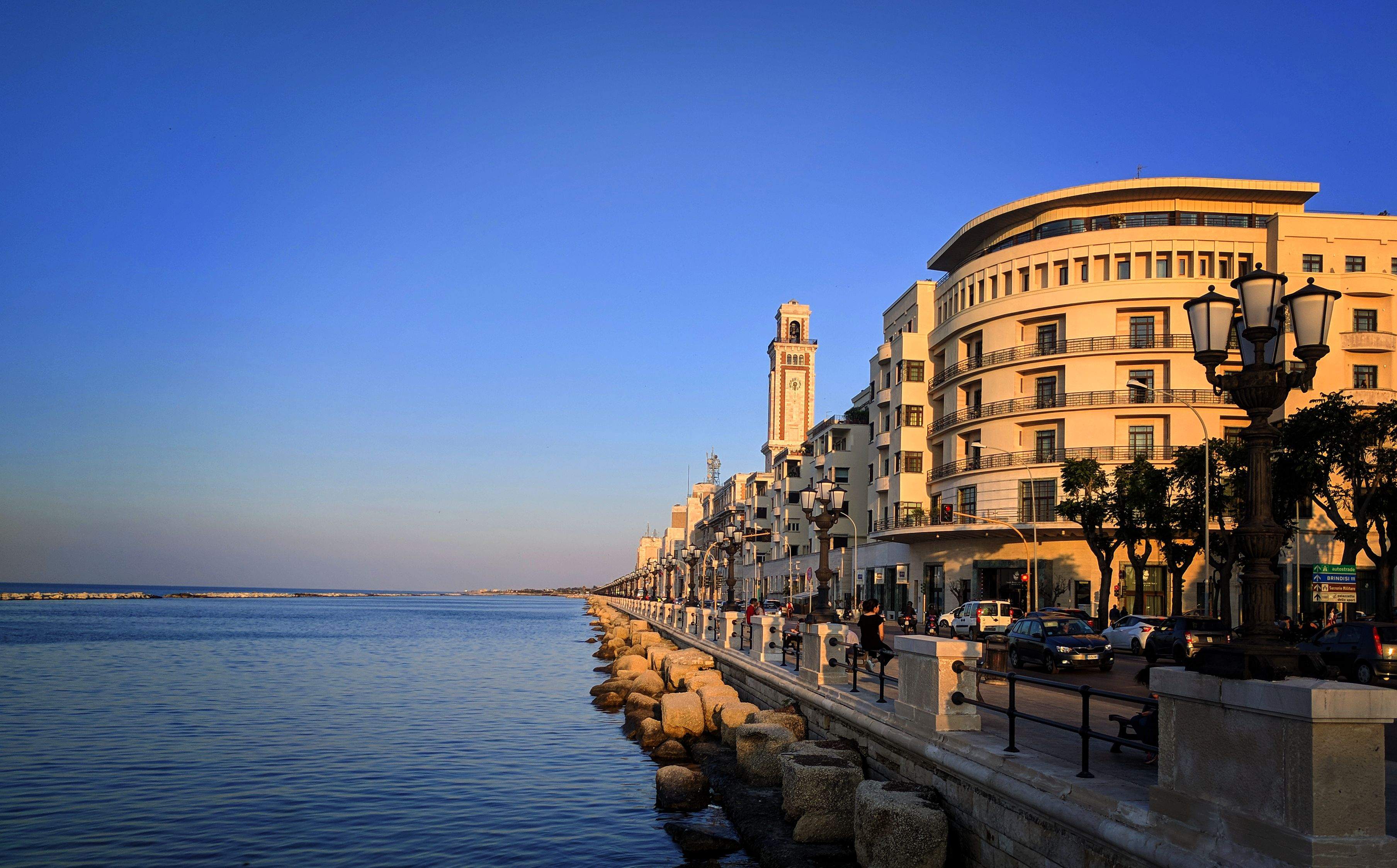 A serene view of the Adriatic Sea in Bari, showcasing calm waters under a clear blue sky.