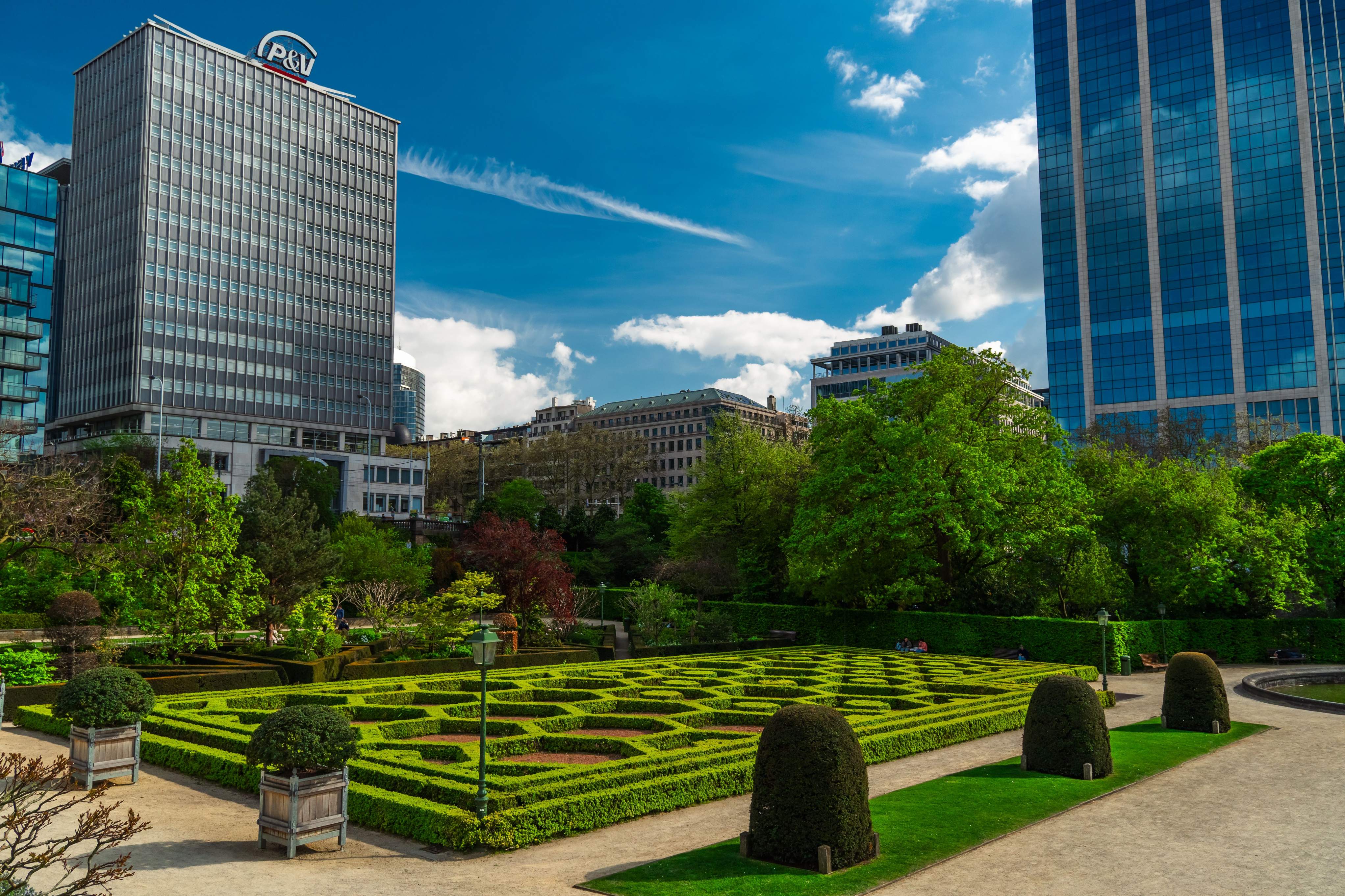 Contemporary skyscrapers rise in Brussels, featuring glass facades and unique designs in the urban skyline.