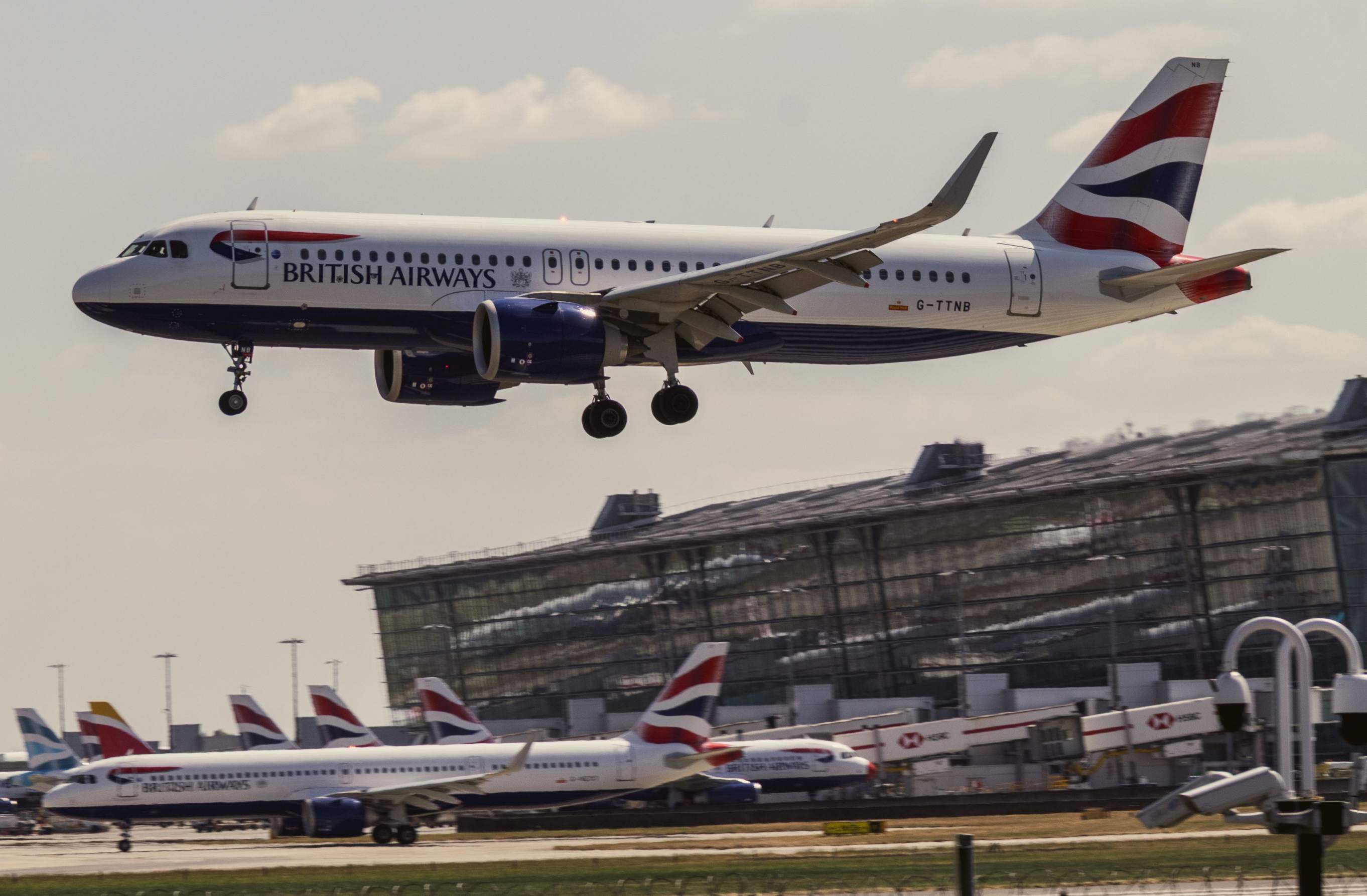 A view of Heathrow Airport with a news alert regarding British Airways' job cuts affecting up to 1,000 employees.