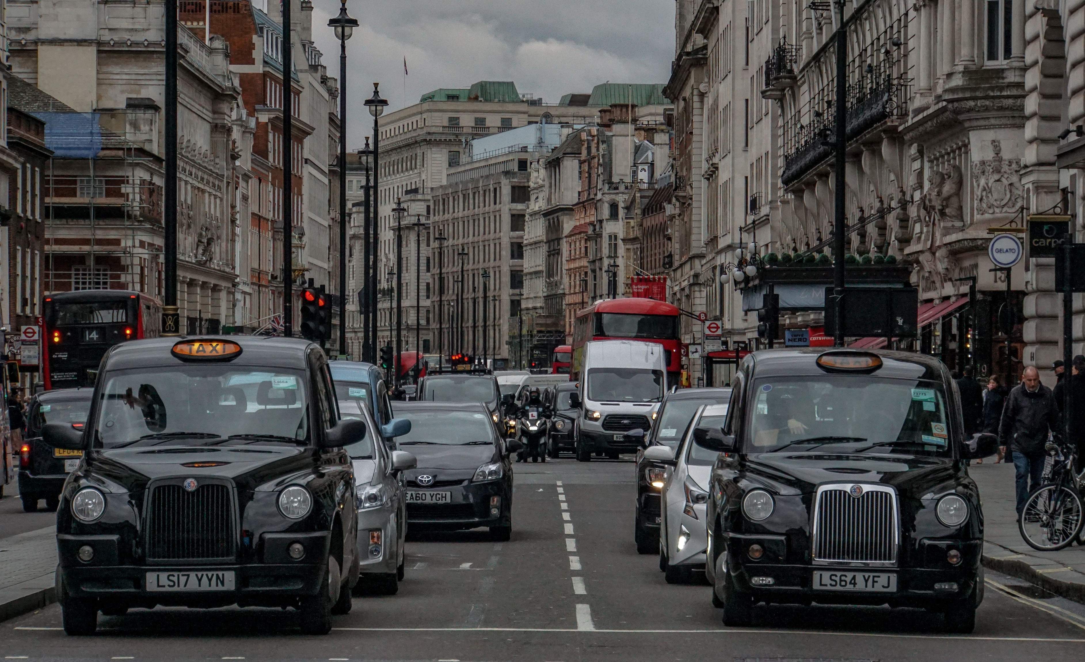 A line of London taxis on the road, showcasing the city's famous transportation.