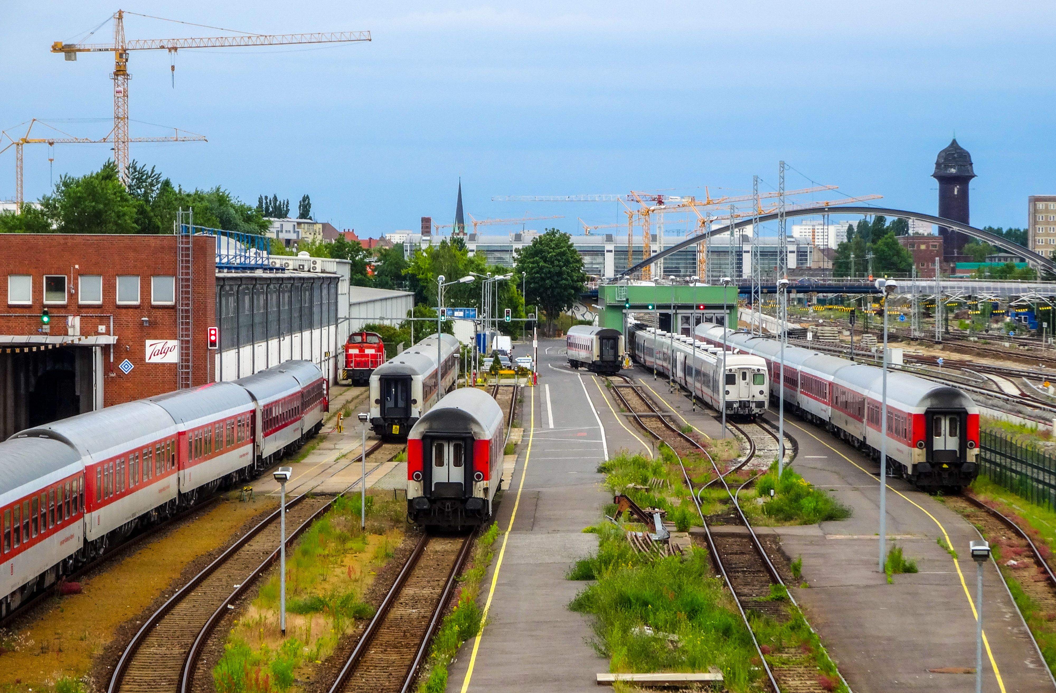 Several trains are stationed on the tracks at a Berlin train station, illustrating the city's public transit system.