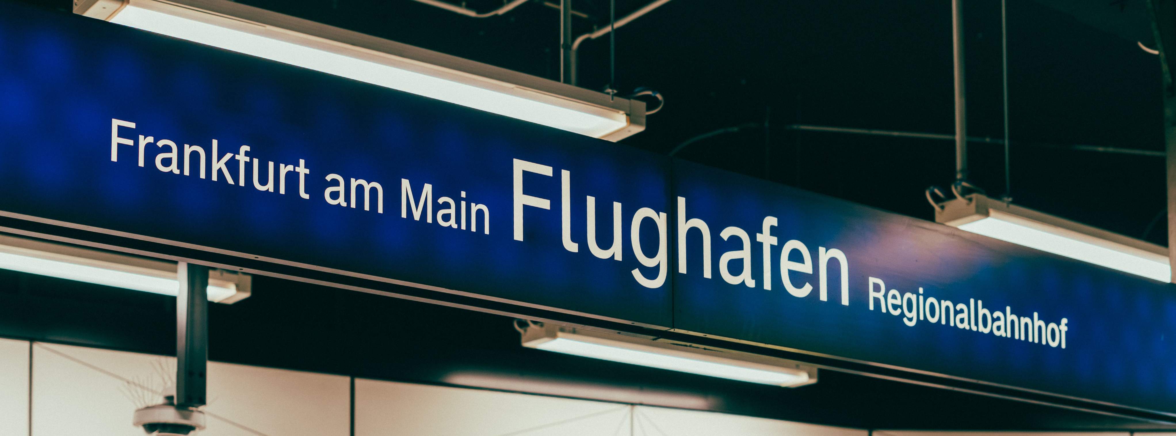 Frankfurt Airport Regional Train Station sign, featuring the name prominently in German.