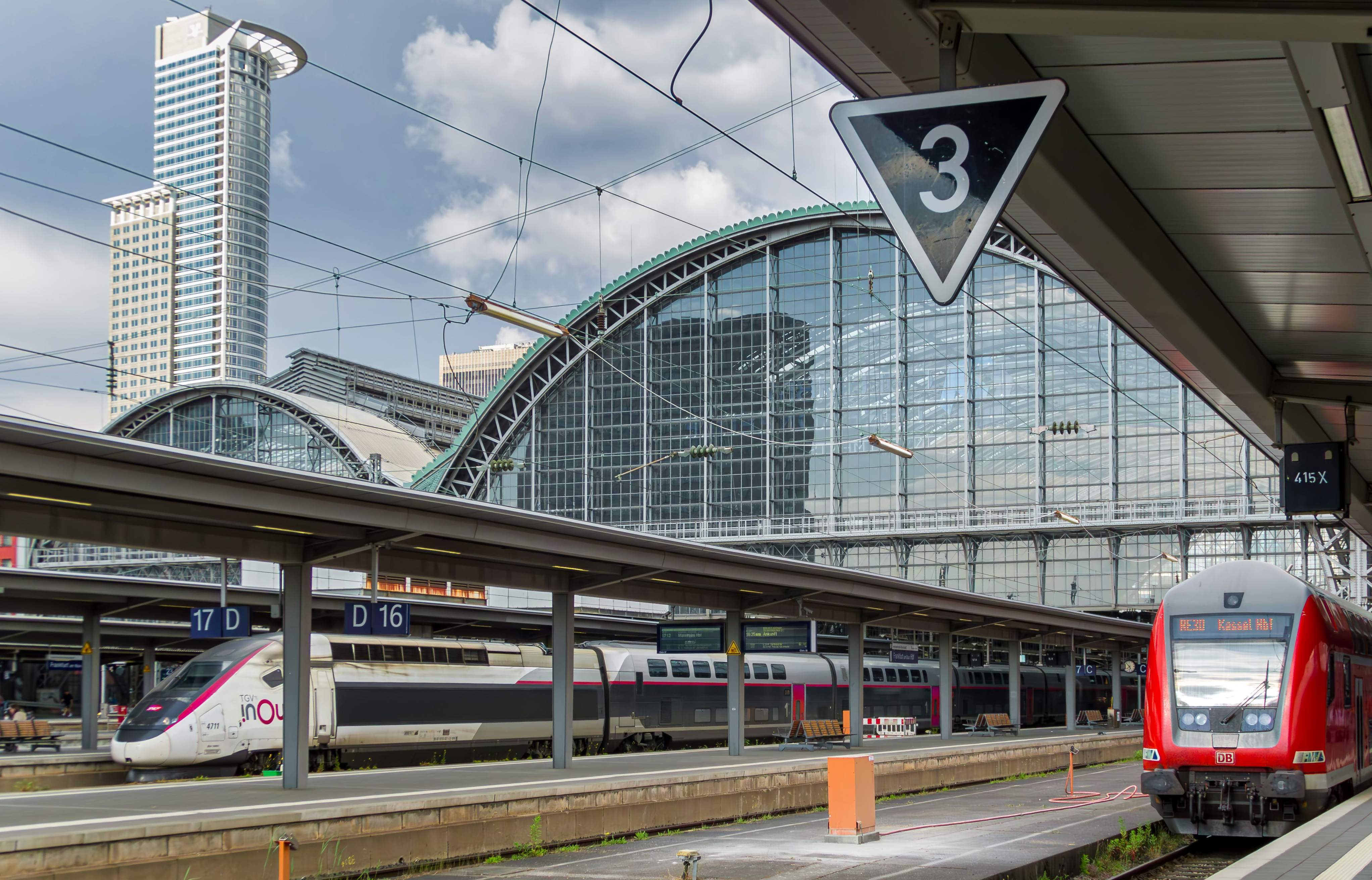 A red and white train traveling from Frankfurt to Rothenburg, showcasing its sleek design and vibrant colors.