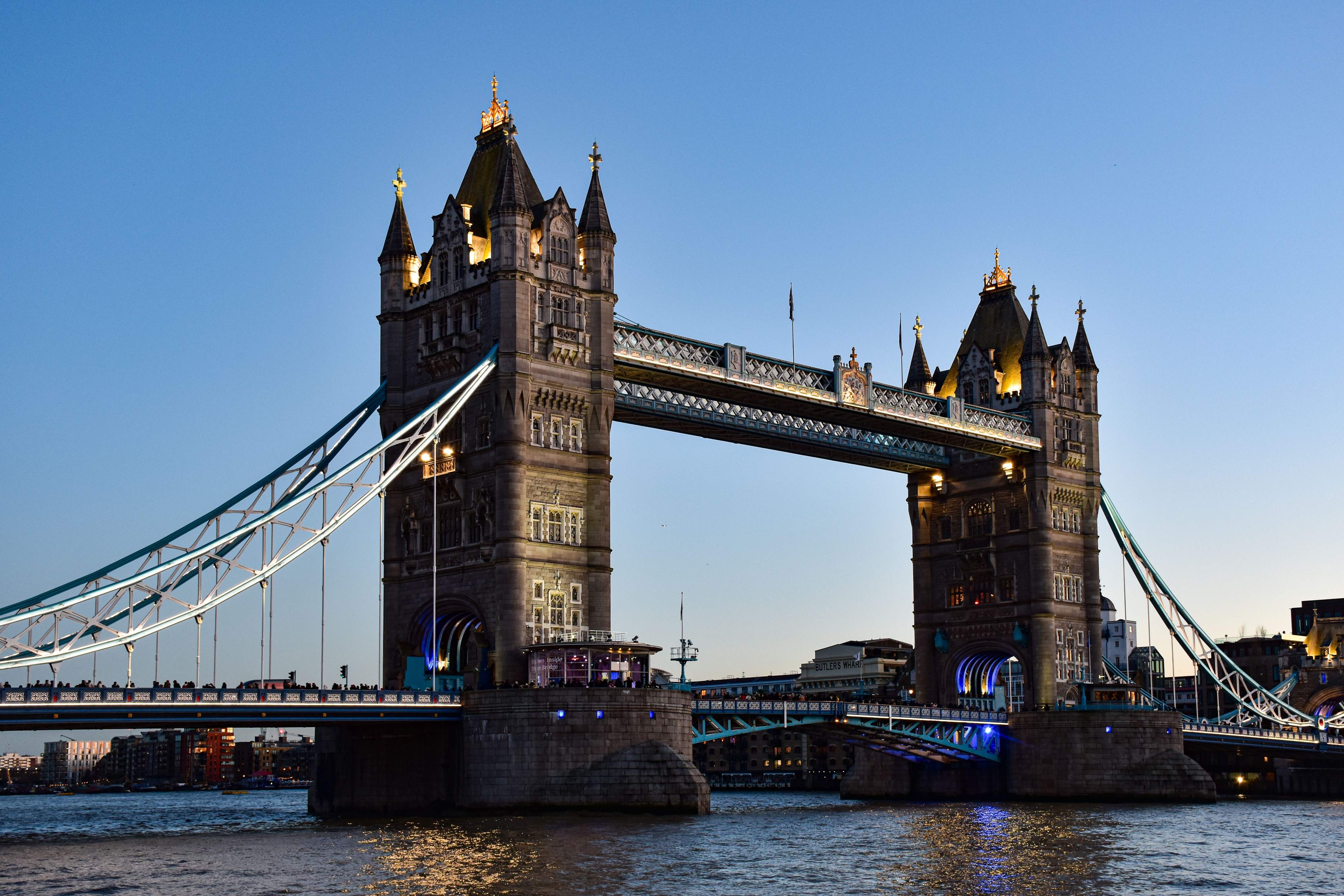 Tower Bridge spans the River Thames in London, showcasing its iconic twin towers and bascule design.