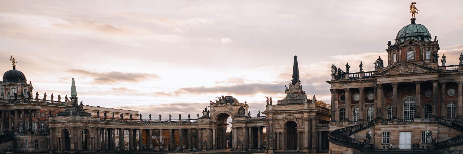 Colonnades of the Palace of Hesse in Potsdam, showcasing classical architecture and elegant columns against a clear sky.