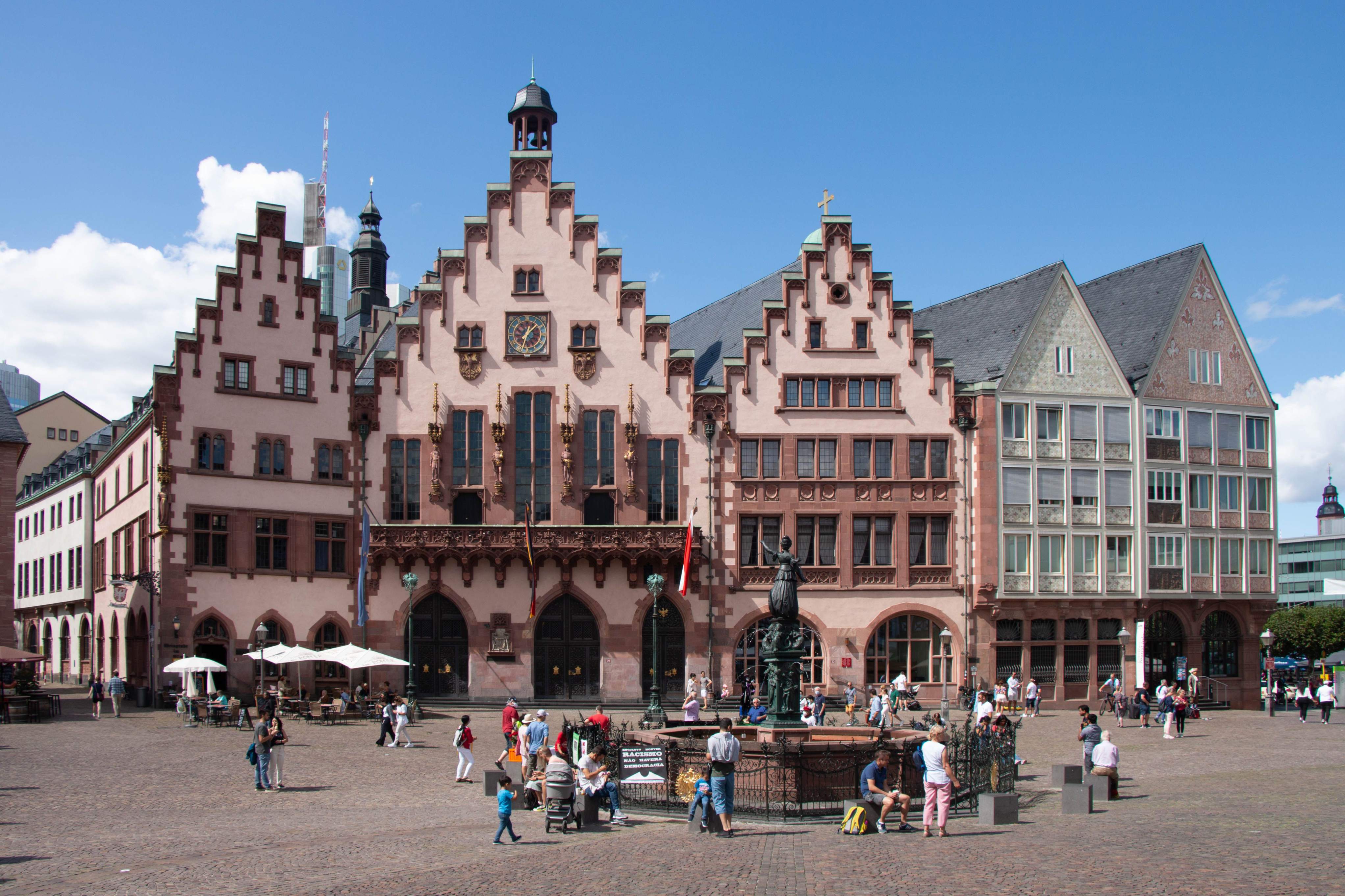 A prominent building featuring an extensive facade of windows, representing Frankfurt's skyline during a layover.