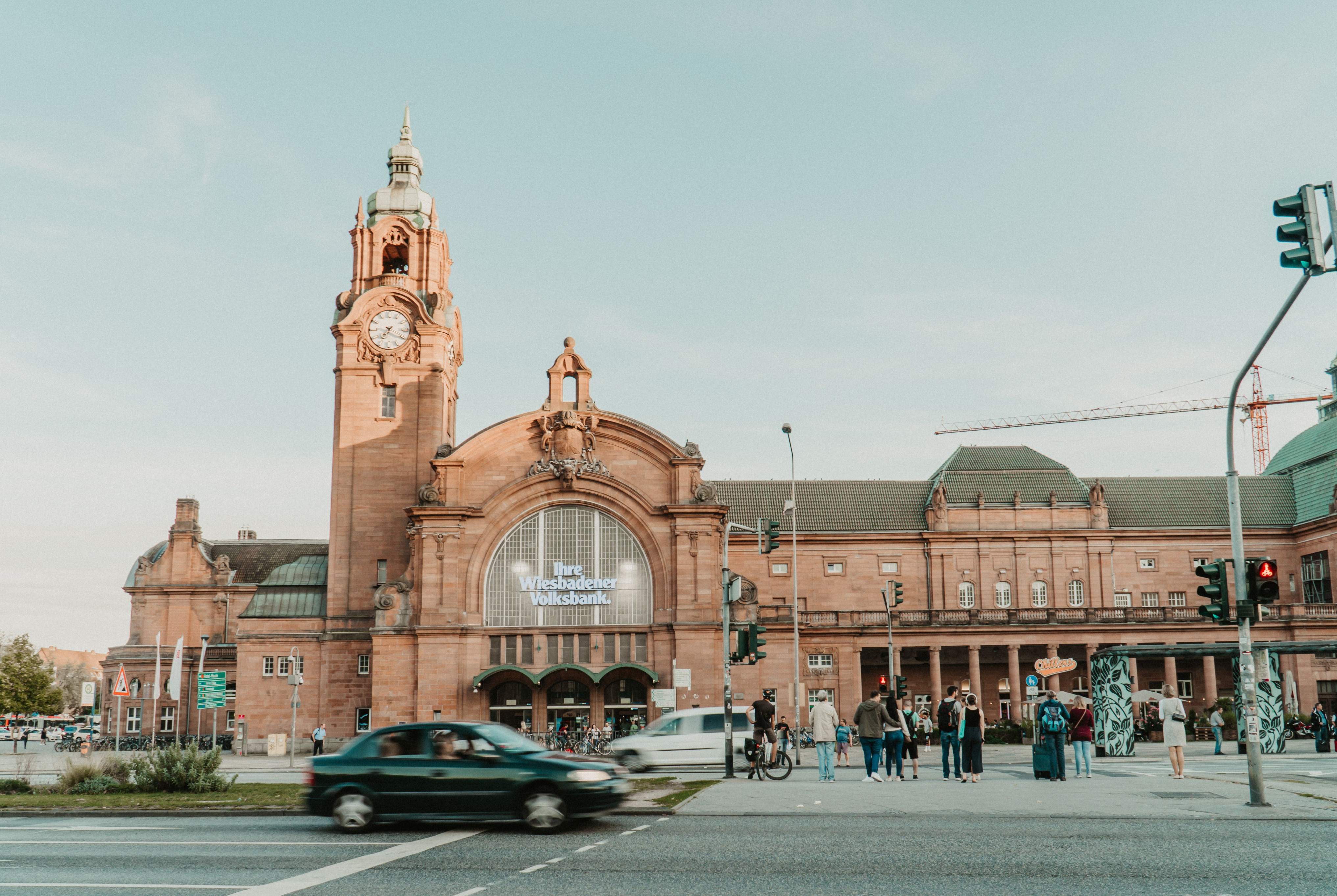 Historic railway station in Wiesbaden featuring a prominent clock tower and classic architectural design.