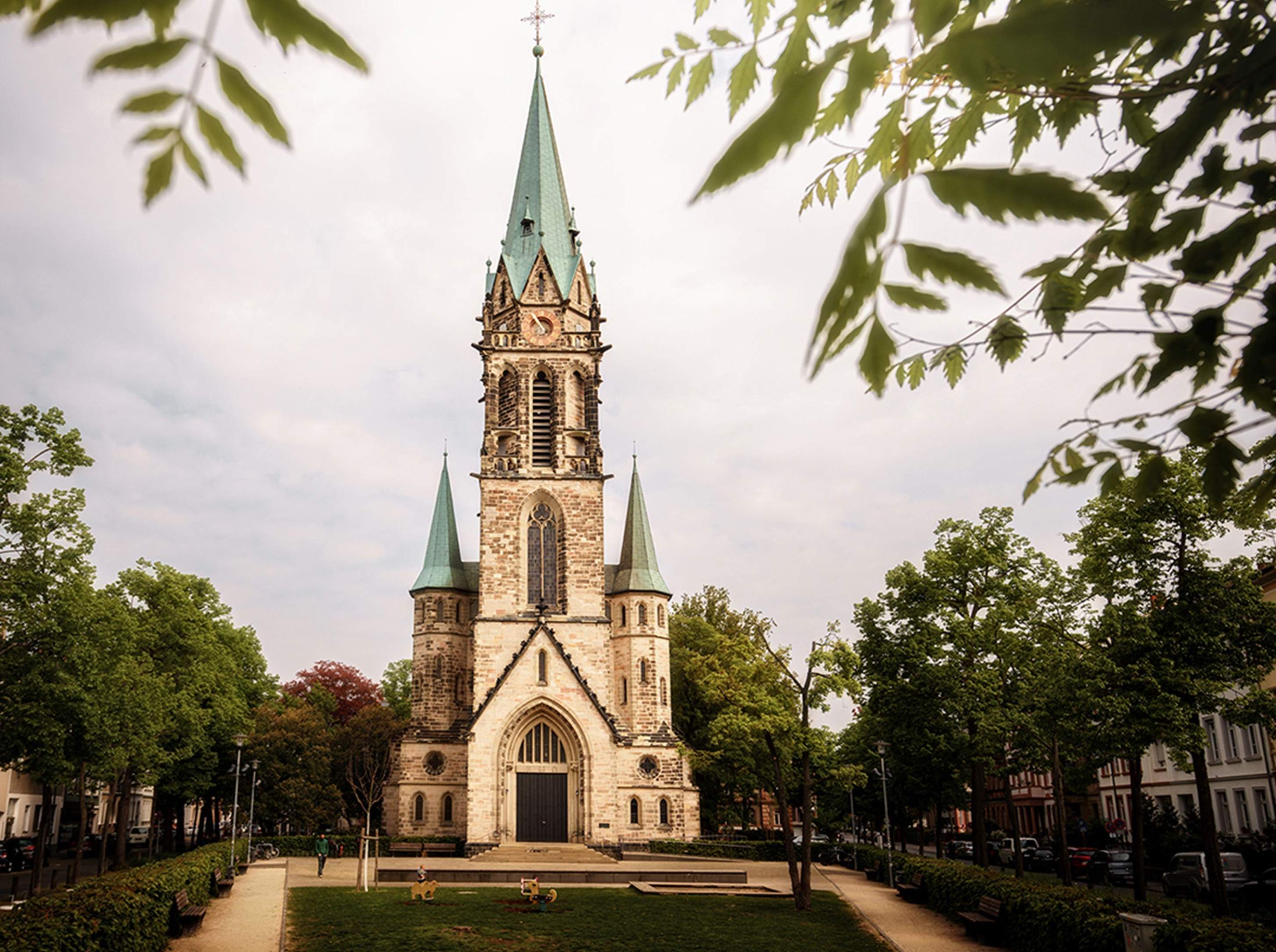Johanneskirche church in Darmstadt, featuring a prominent steeple amidst urban buildings.